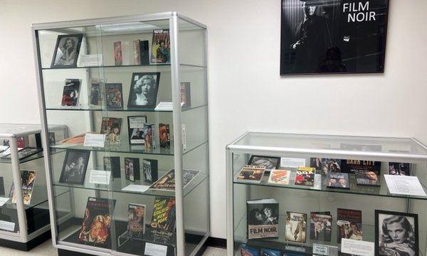 display cases with videos, photos and books