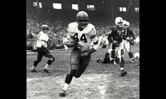 B&W still of football player wearing #44