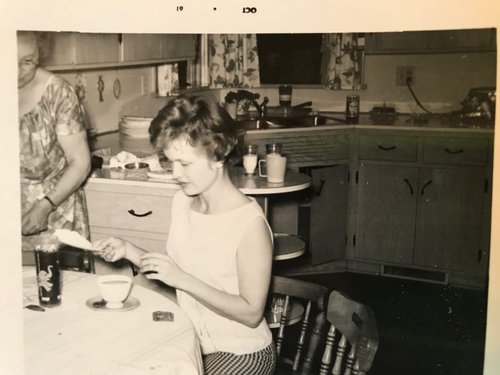 Woman sitting at table in the 1950s.