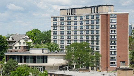 multi-story building with circular attachment near front of building