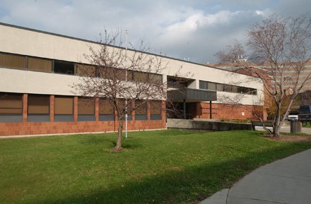 two story building with lower half brick and upper half tan color