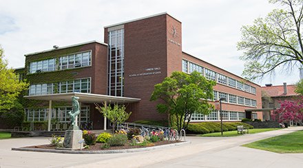 L-shaped multi-level red brick building