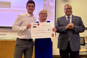 student with a prize check (Left to right) Justin Gluska with Gisela vonDran and Dean of the iSchool Raj Dewan
