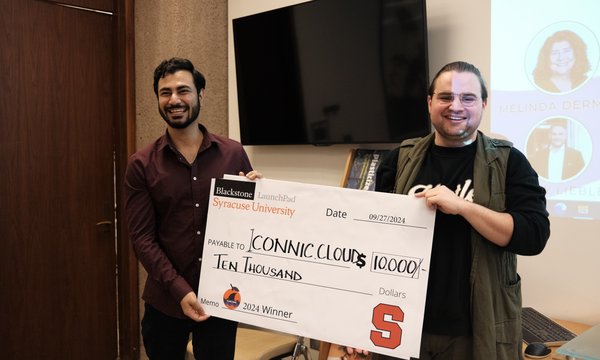 two men holding oversized check