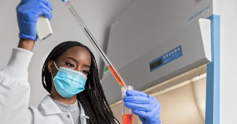 Ify Ojukwu doing experiment in a lab