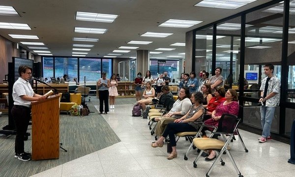 person reading from banned book at podium