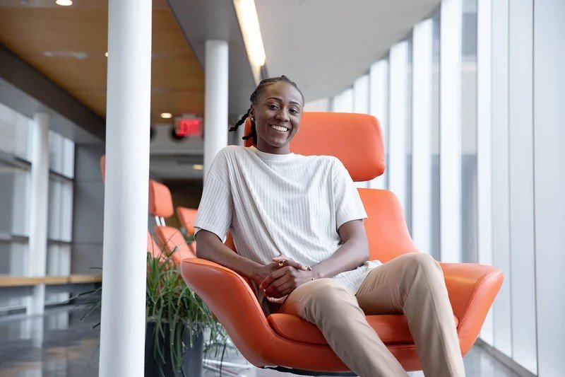 woman sitting on orange chair