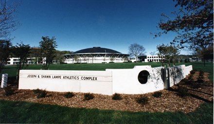 corner white wall with words "Joseph and Shawn Lampe Athletics Complex"