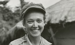 Marguerite Higgins smiling and wearing a hat