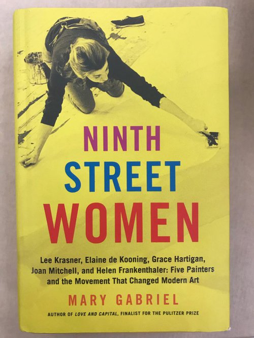 Yellow book cover with a woman creating art above the title.