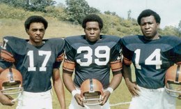 Three Syracuse 8 members in football jerseys with numbers 17, 39 and 14