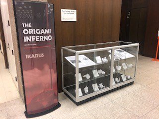 poster that reads "The Original Inferno, Ikarus" next to glass display case