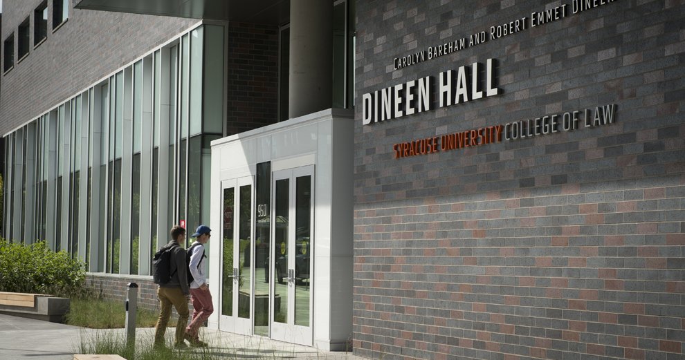 Two students walking inside Dineen Hall