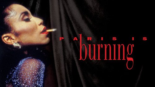 profile of black person with long lashes, red lipstick, beaded dress and earrings with cigarette in their mouth; background is black curtain and words "Paris is burning" in red