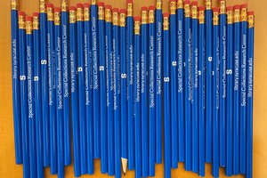 blue pencils lined up on table