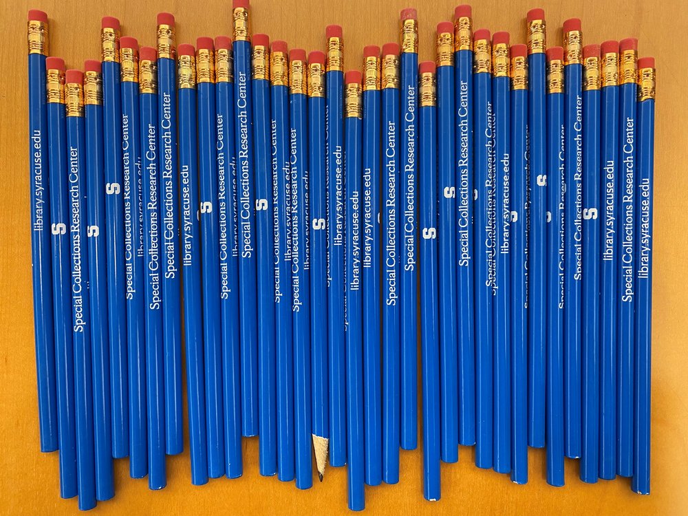 blue pencils lined up on table