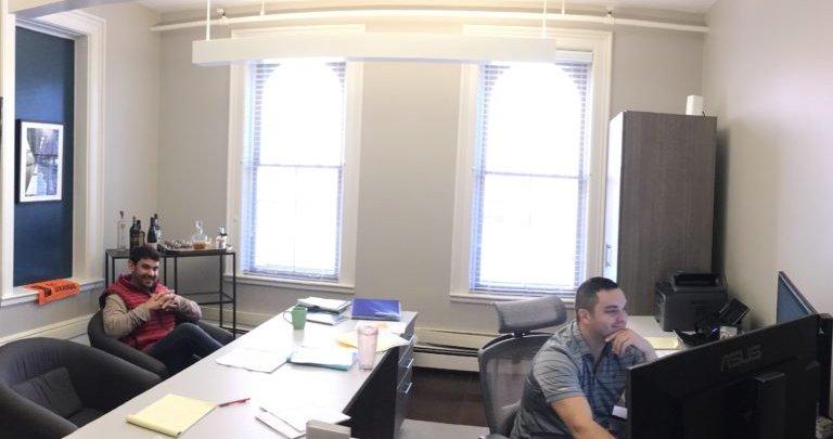 two men sitting in an office