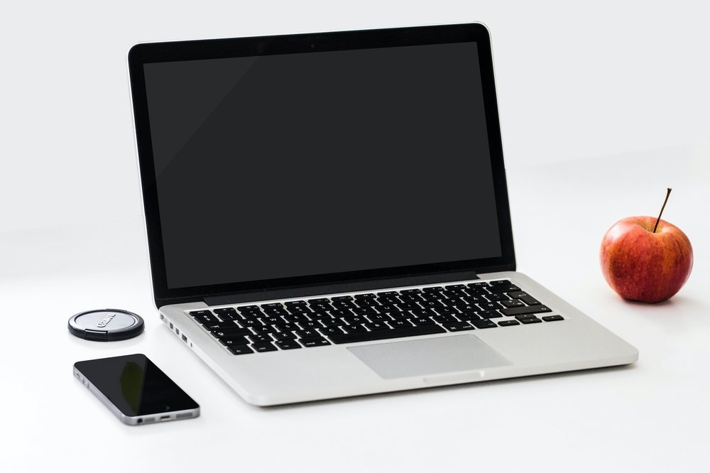 laptop, cell phone and apple