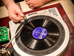 hand placing needle on 78 RPM record on a turntable