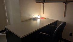 dim lit room with small lamp on desk