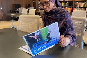 female looking at magazine in Special Collections