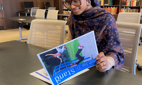 female looking at magazine in Special Collections