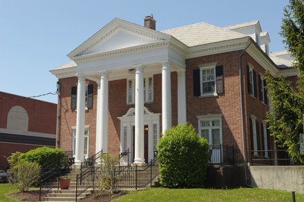 brick house with four long white columns in front