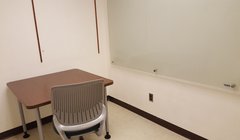 small private room with table, chair and whiteboard