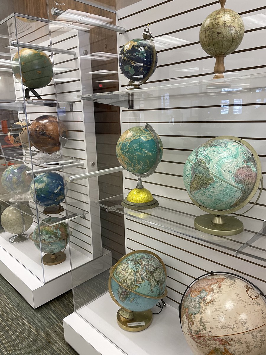 display case with variety of globes inside the case