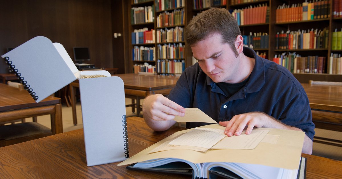 Student researcher in library