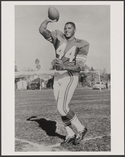 Ernie Davis throwing a football