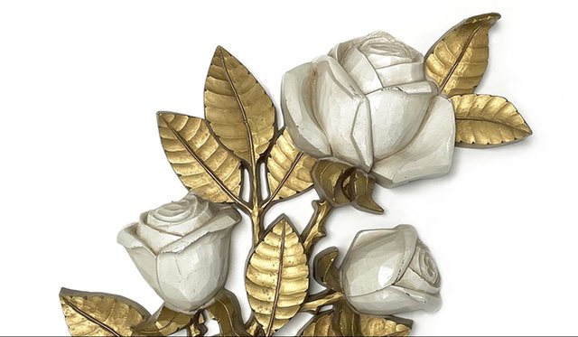 Ornate carving with gold leaves and white roses
