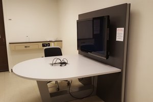room with table, chair and screen