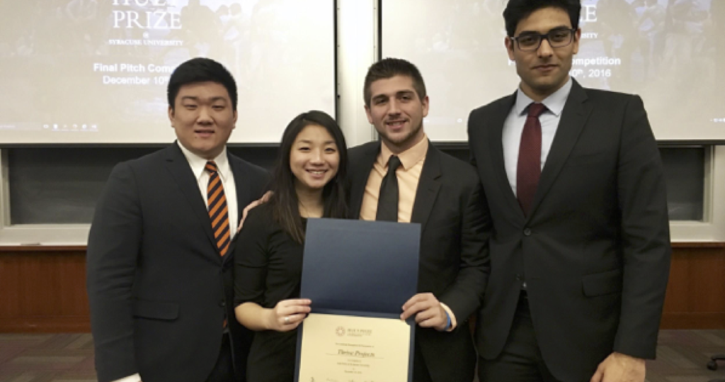 4 students in business attire pose for a photo