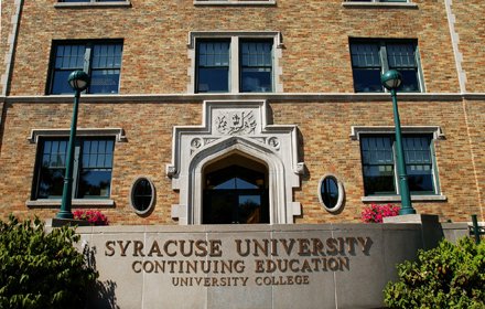 brick building that has wall in front inscribed with "Syracuse University Continuing Education University College"