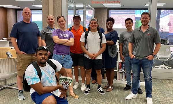 group of people posing in front of LaunchPad in Bird Library