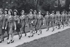 females marching wearing military uniforms