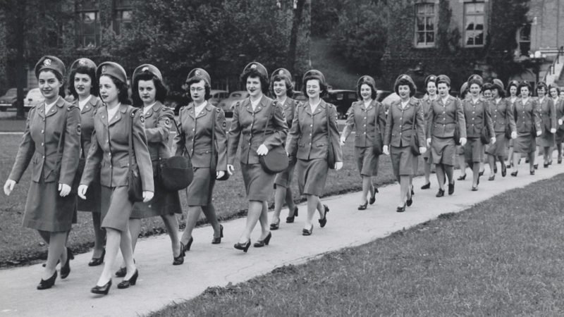 females marching wearing military uniforms