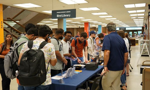 students standing around table with items from special collections on table