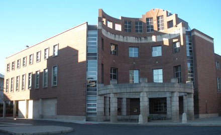 brick building with semi-circle concave entrance
