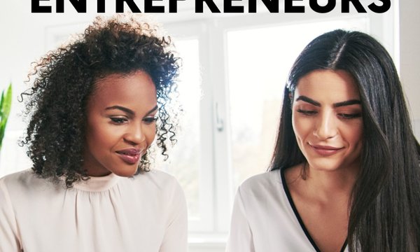 two women looking at laptop